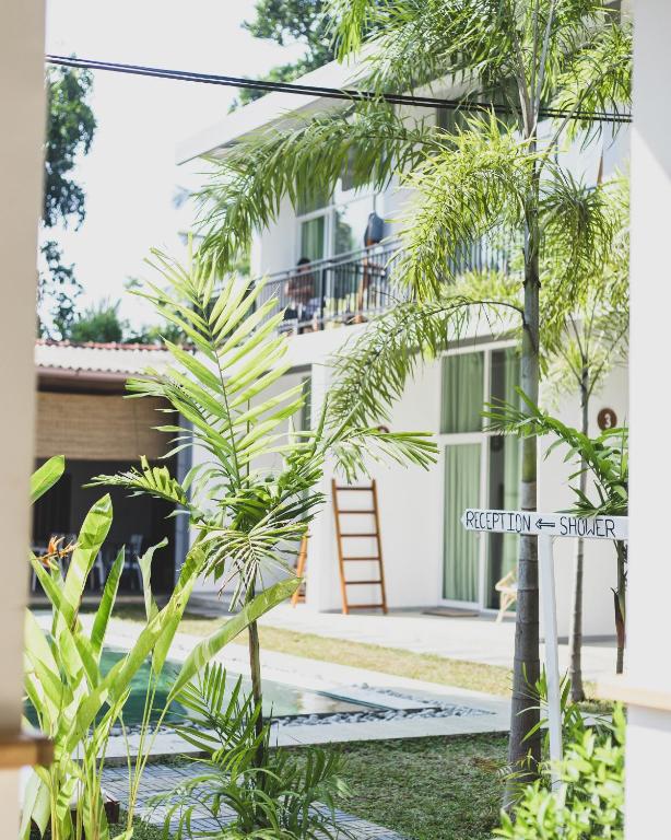 a view of the front of a house with palm trees at Green Hill Mirissa in Mirissa