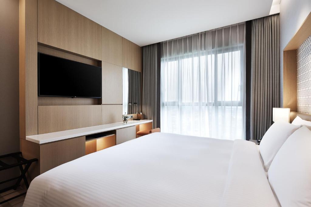 Postel nebo postele na pokoji v ubytování Landing Jeju Shinhwa World Hotel