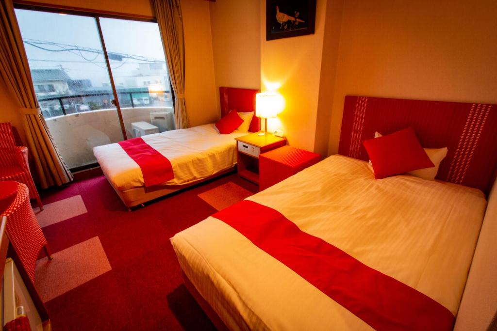 Postel nebo postele na pokoji v ubytování SPA Inn Shirahama