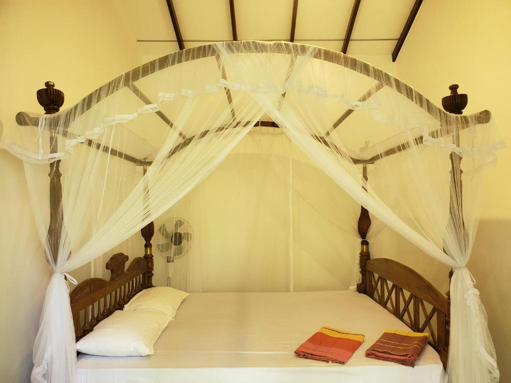 Postel nebo postele na pokoji v ubytování Sigiriya River Side Villa