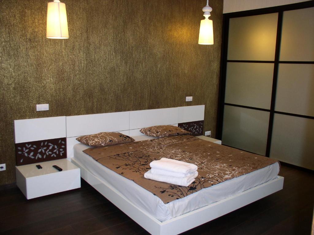 a bedroom with a bed with towels on it at One bedroom luxury Shota Rustaveli str in Kyiv
