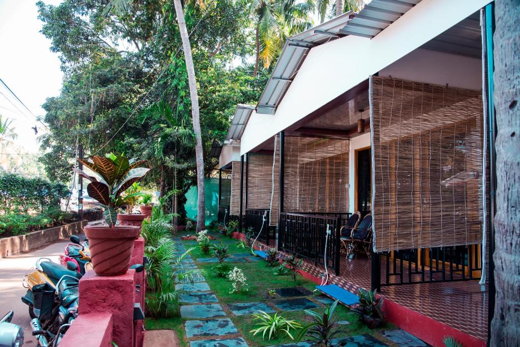 a house with a garden in front of it at Patnem Beach Cottages in Patnem