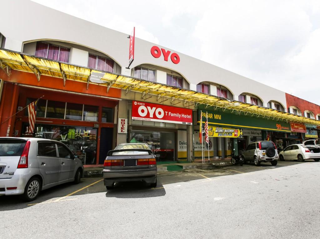 un bâtiment avec des voitures garées devant lui dans l'établissement OYO 89615 T Family Hotel, à Klang