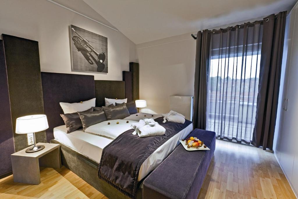 a bedroom with a large bed and a large window at Art Hotel Superior in Aachen