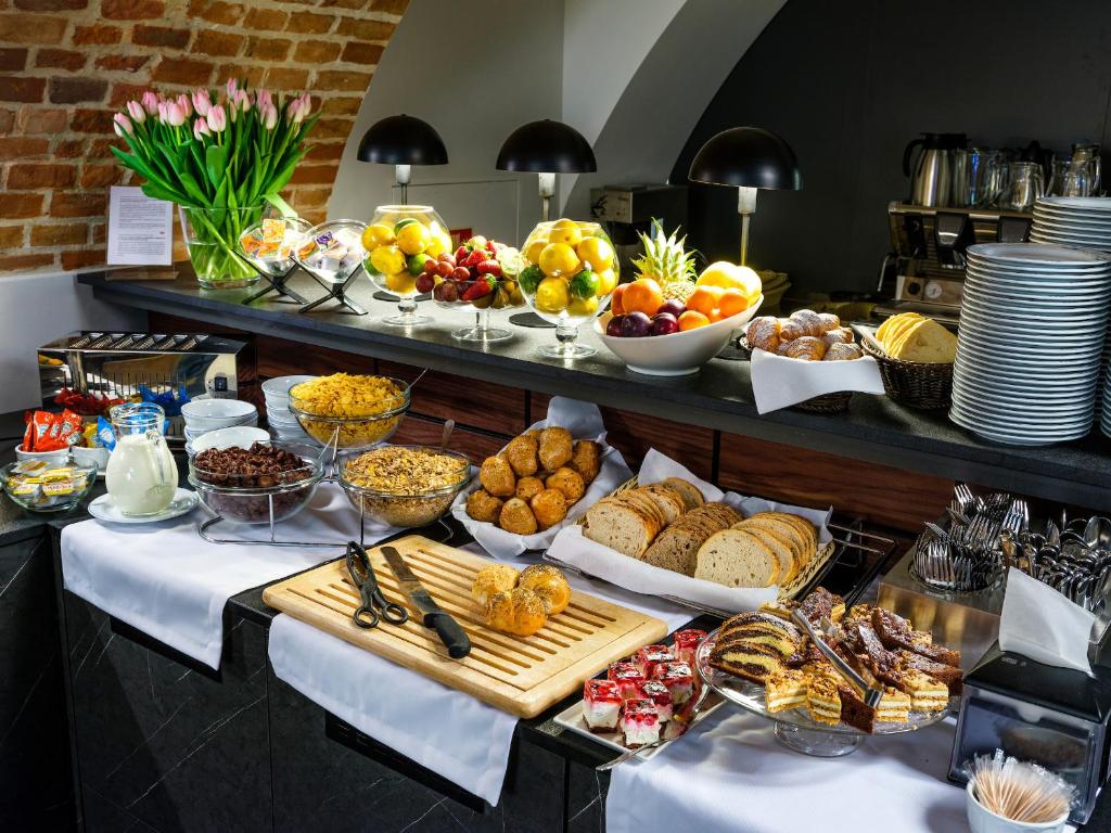 a buffet with many different types of food on a table at Hotel Logos Kraków in Krakow