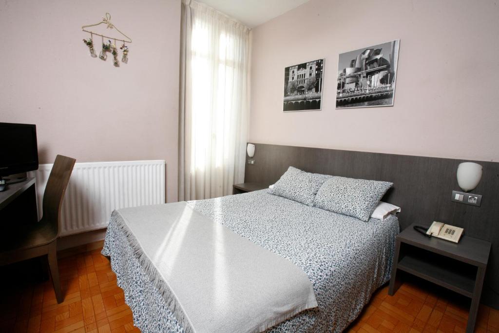Postel nebo postele na pokoji v ubytování Hotel Ripa