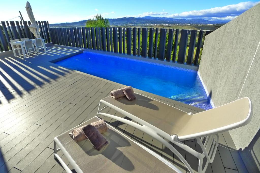 una terraza con una silla y una piscina en Nº43 Baviera Golf en Caleta De Velez