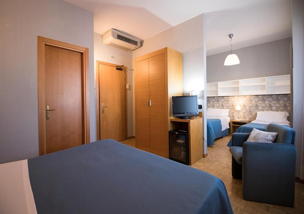 Postel nebo postele na pokoji v ubytování Hotel Clarici