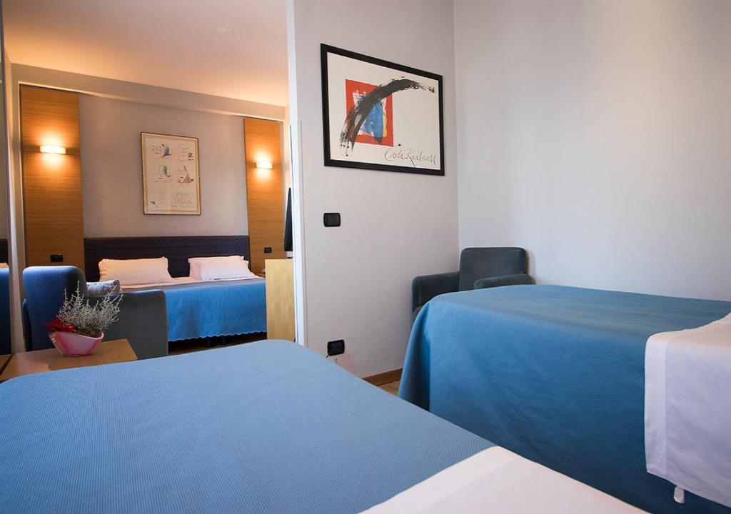 Postel nebo postele na pokoji v ubytování Hotel Clarici