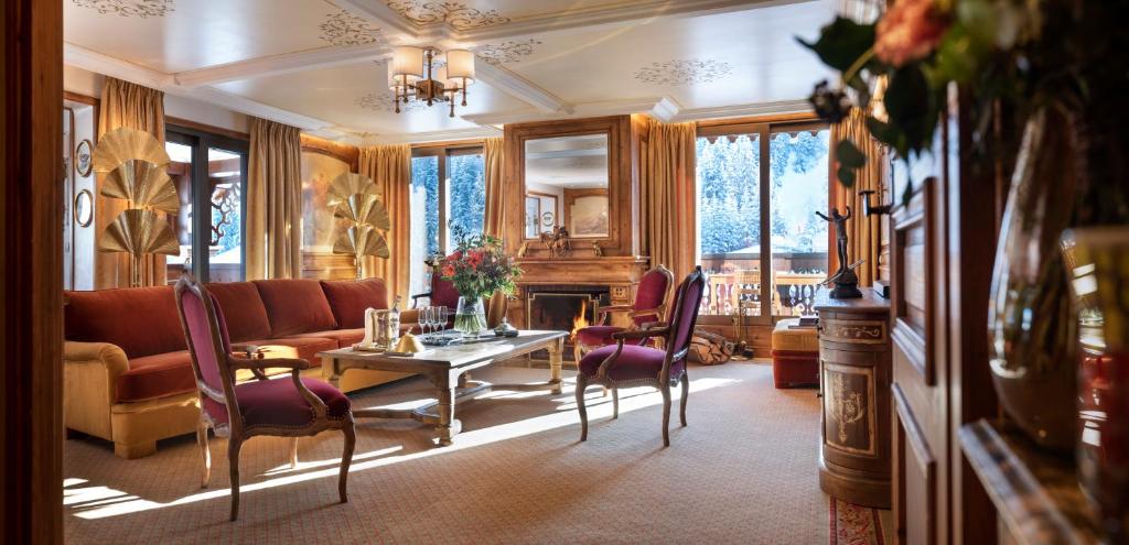a living room with a couch and a table and chairs at Appartements d'Exception in Courchevel
