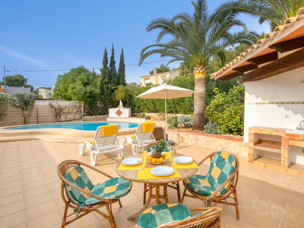 a patio with a table and chairs and a pool at Holiday Home La Concha by Interhome in Balcon del Mar