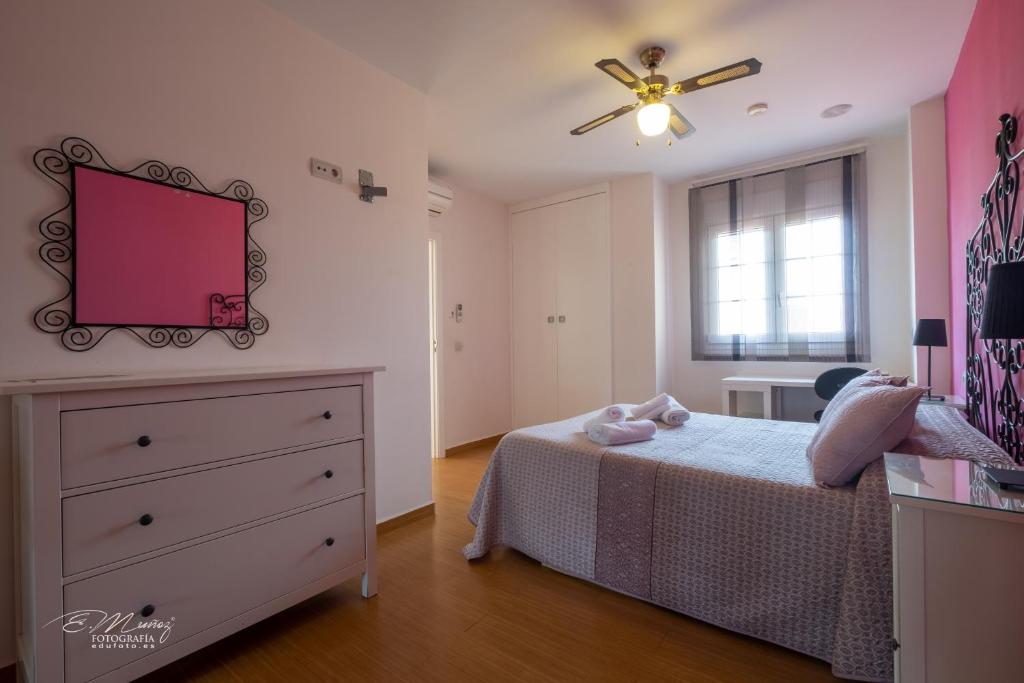 A bed or beds in a room at Apartamentos Mérida Center