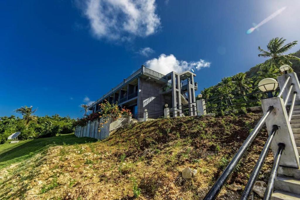a house on top of a hill at Saipan Skyline Designers Hotel in Saipan