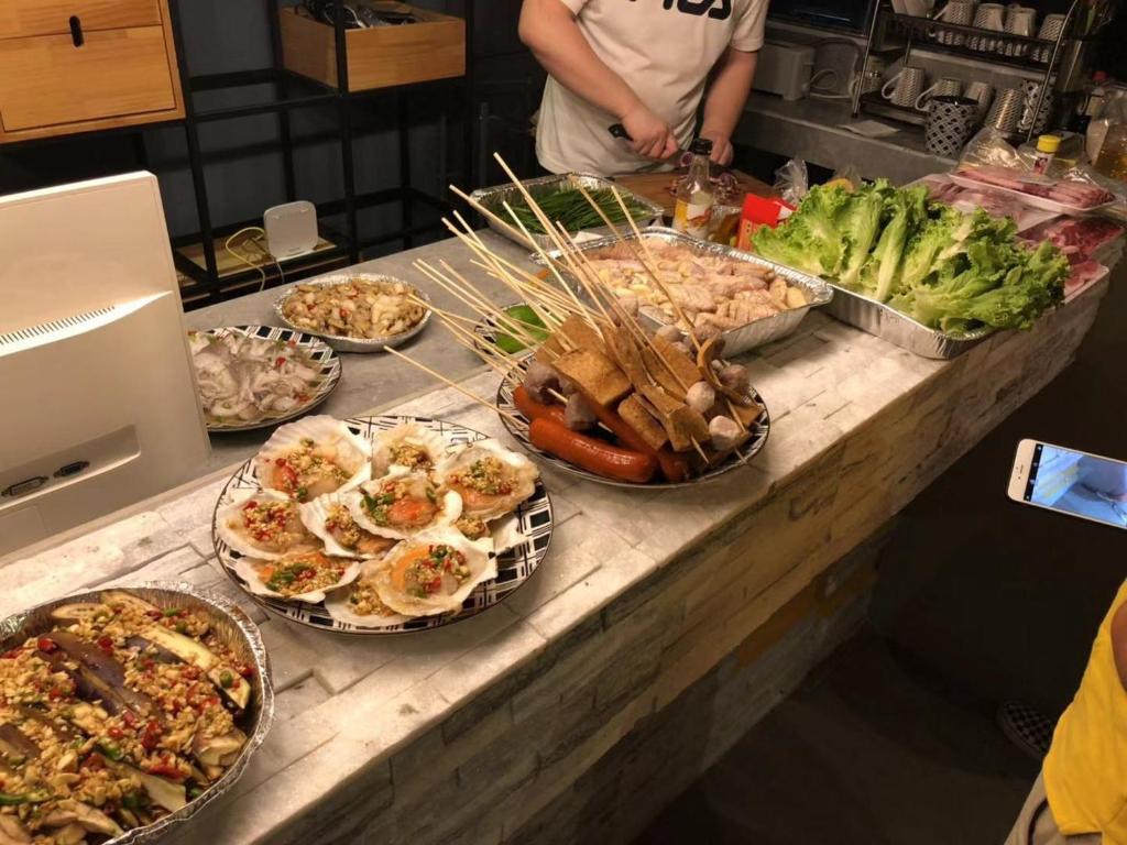a counter with many different types of food on it at Saipan Skyline Designers Hotel in Saipan