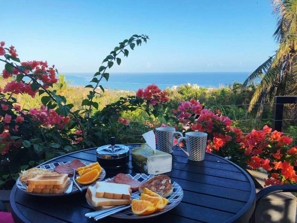 a blue table with a plate of food on it at Saipan Skyline Designers Hotel in Saipan