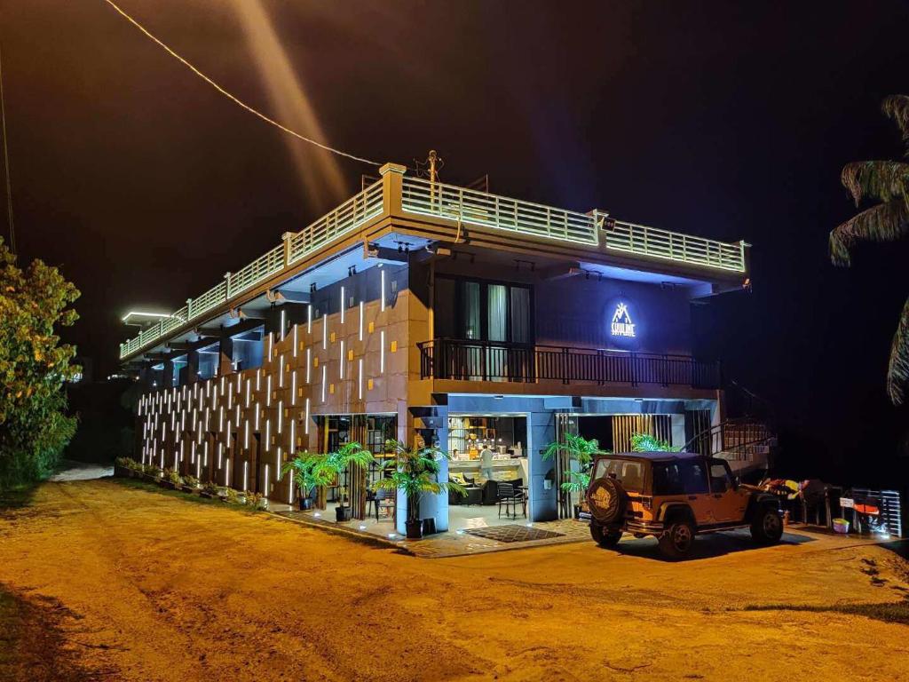 a building with a jeep parked in front of it at Saipan Skyline Designers Hotel in Saipan