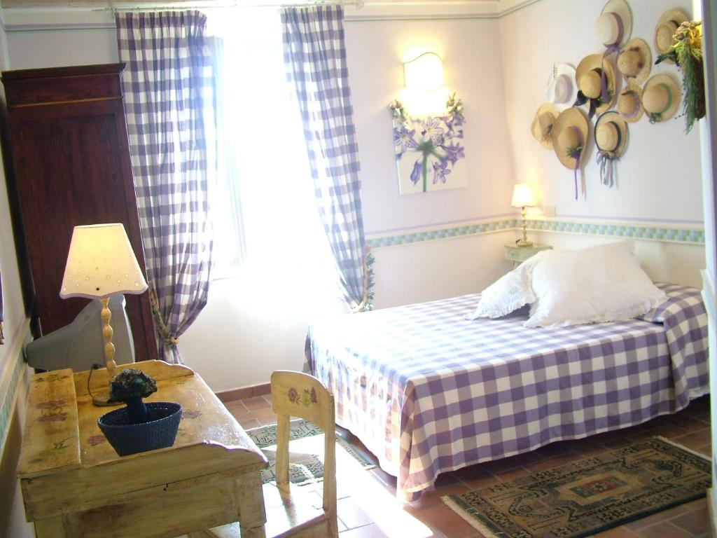 a bedroom with a bed and a table and a window at La Meridiana in Lanuvio