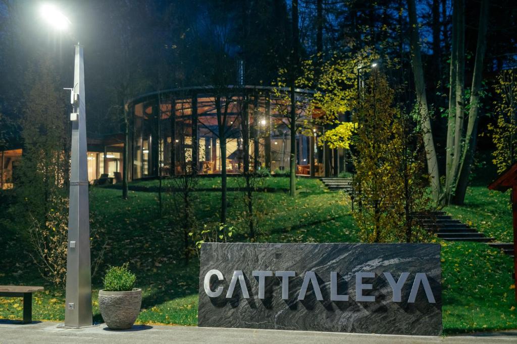 a sign in front of a building at night at Resort CATTALEYA in Čeladná