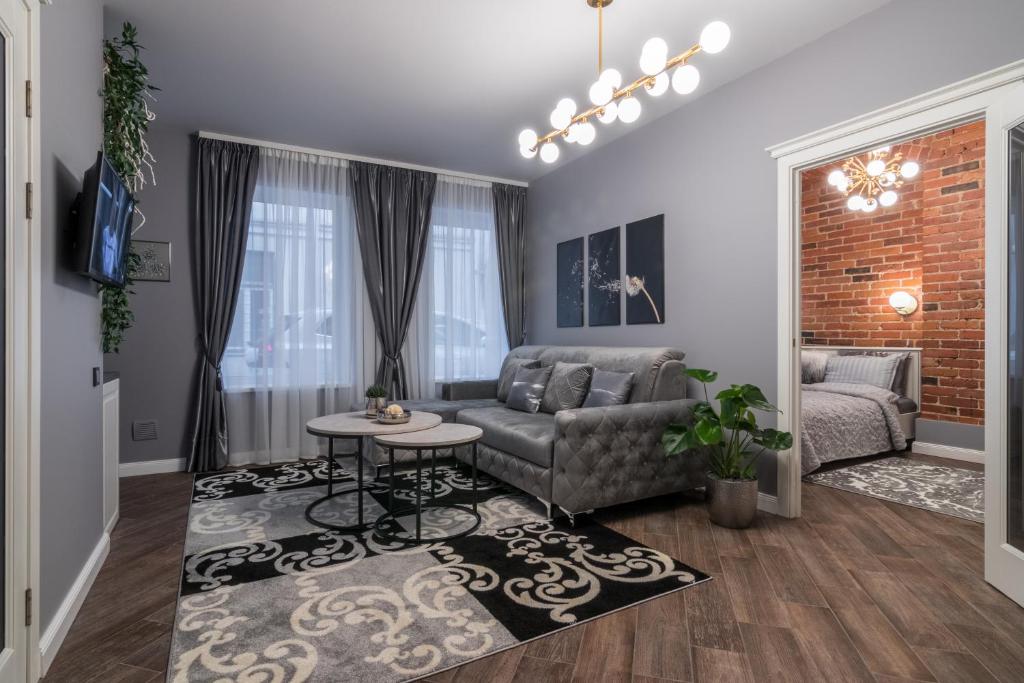a living room with a couch and a table at Dandelion apartment in the heart of Kaunas in Kaunas