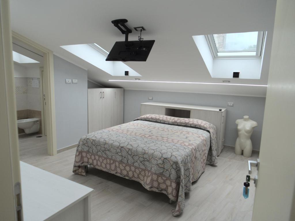 a bedroom with a bed and a skylight at DADA in Giffoni Valle Piana