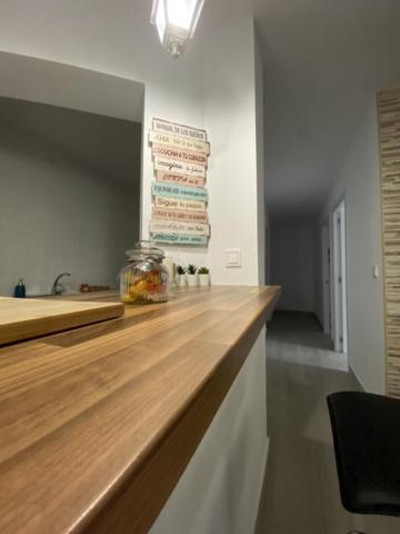 a kitchen with a wooden counter top in a room at WISH SUITE NIEBLA DE SEVILLA in Seville
