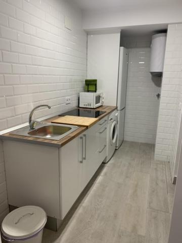 a small kitchen with a sink and a toilet at WISH SUITE NIEBLA DE SEVILLA in Seville
