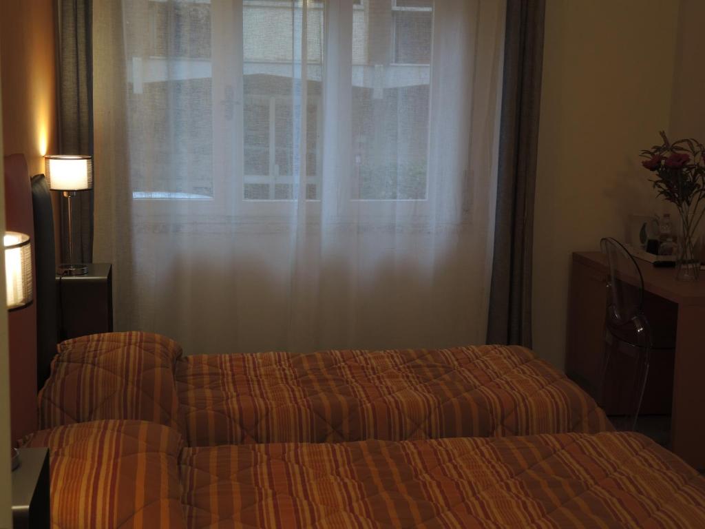 Postel nebo postele na pokoji v ubytování B&B Ariston Pisa Tower