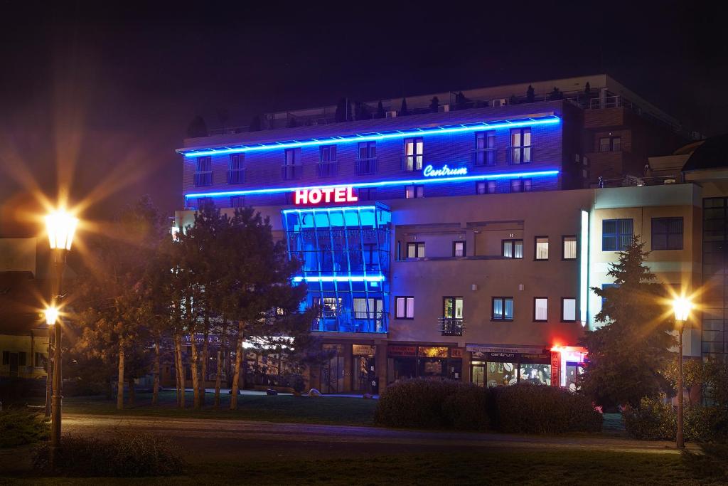 a hotel with blue lights on a building at night at Hotel Centrum in Nitra