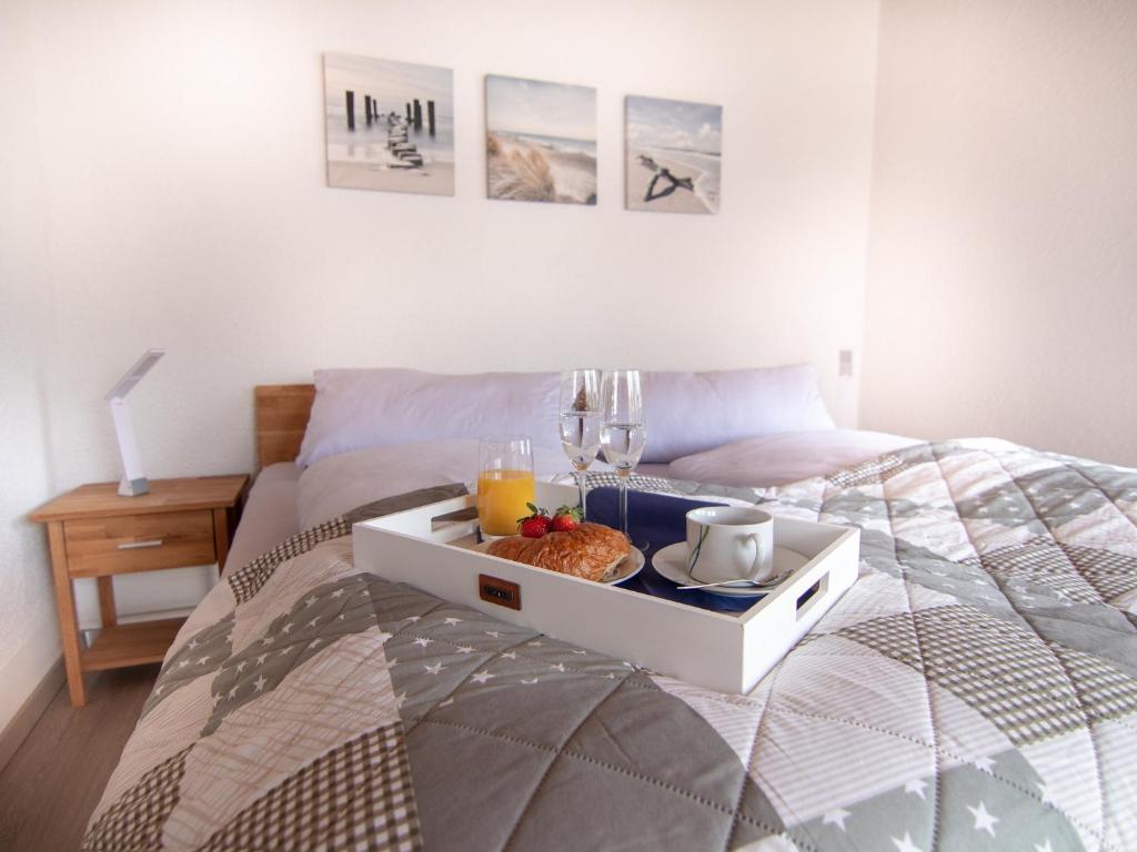 a bed with a tray of food on top of it at Appartement Ludwigskanal in Schwarzenbruck