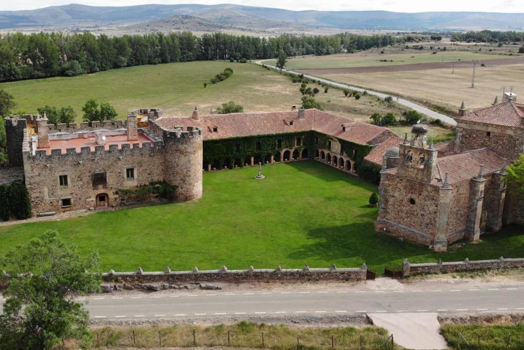 una vista aérea de un antiguo castillo con un campo verde en Casa rural Casa Fuerte San Gregorio I en Almarza