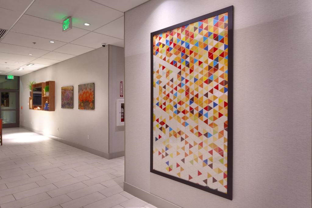 a large colorful painting on a wall in a hallway at Holiday Inn Express & Suites Phoenix West - Buckeye by IHG in Buckeye
