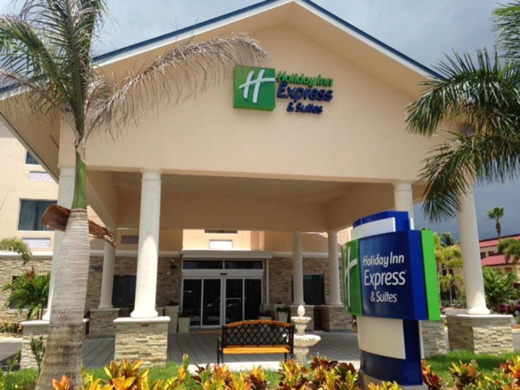 a front view of a hospital building with a palm tree at Holiday Inn Express & Suites Lantana, an IHG Hotel in Lantana