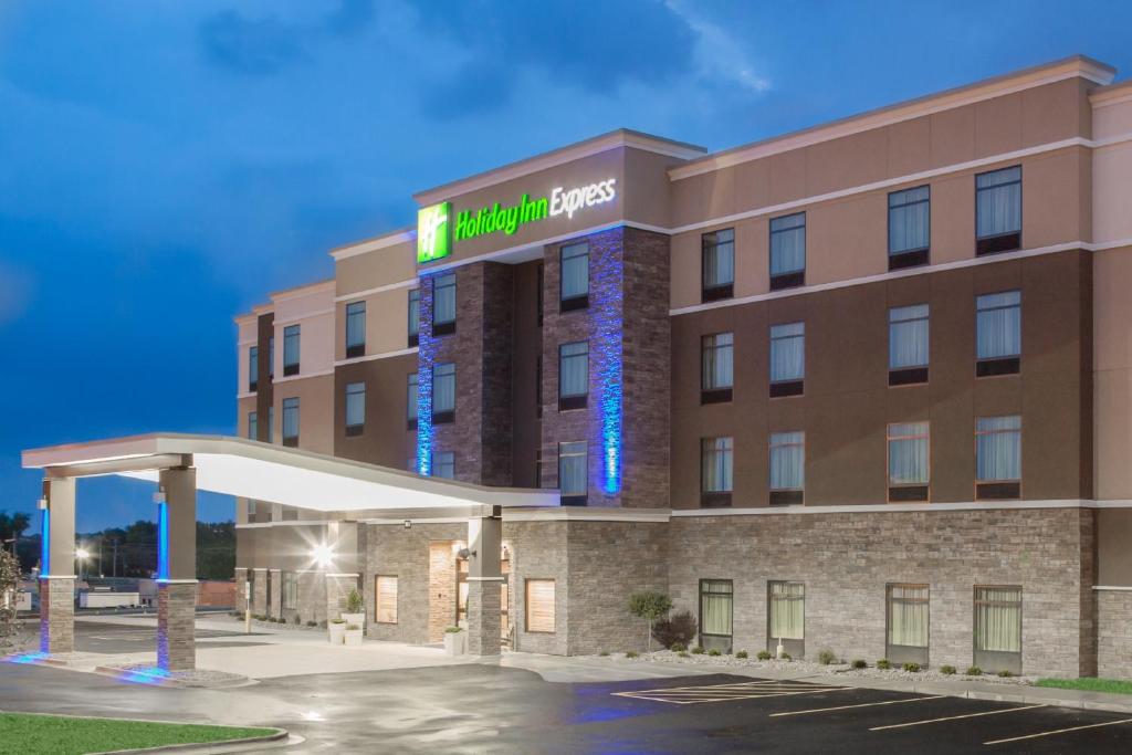a rendering of a hotel with a gas station at Holiday Inn Express Moline - Quad Cities Area, an IHG Hotel in Moline