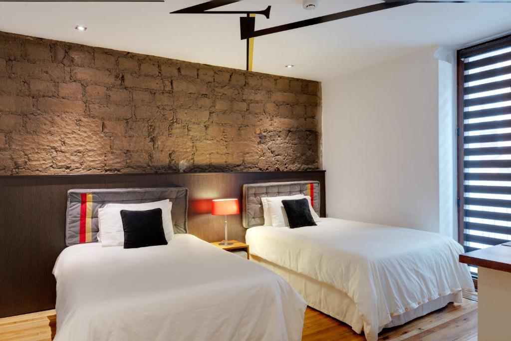 Postel nebo postele na pokoji v ubytování Hotel Casa Gardenia