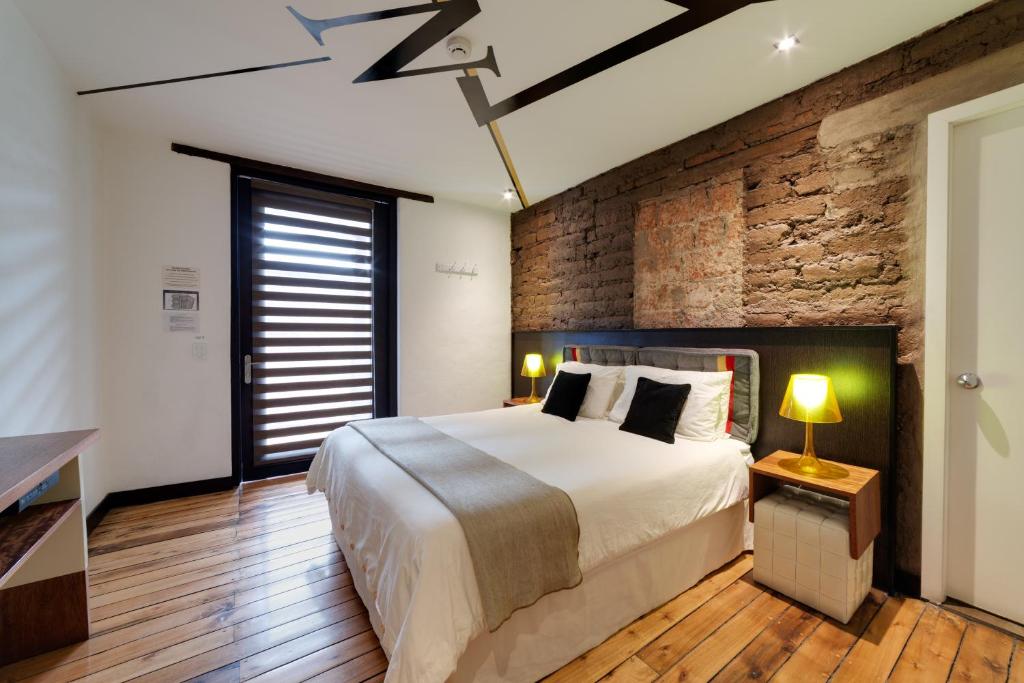 Postel nebo postele na pokoji v ubytování Hotel Casa Gardenia