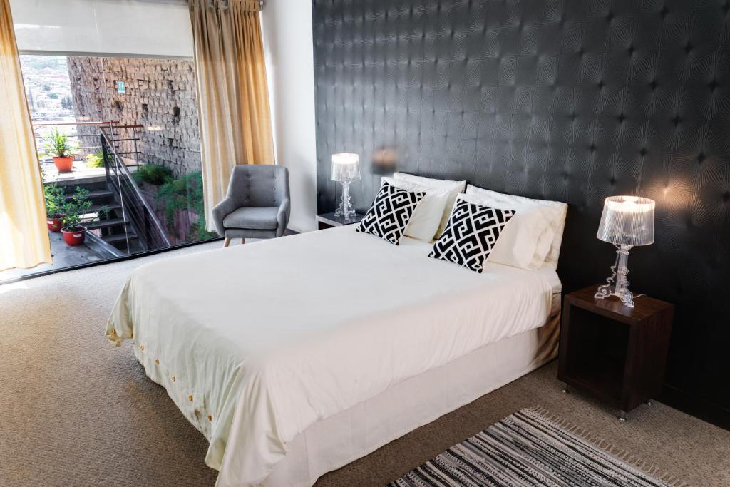 Postel nebo postele na pokoji v ubytování Hotel Casa Gardenia