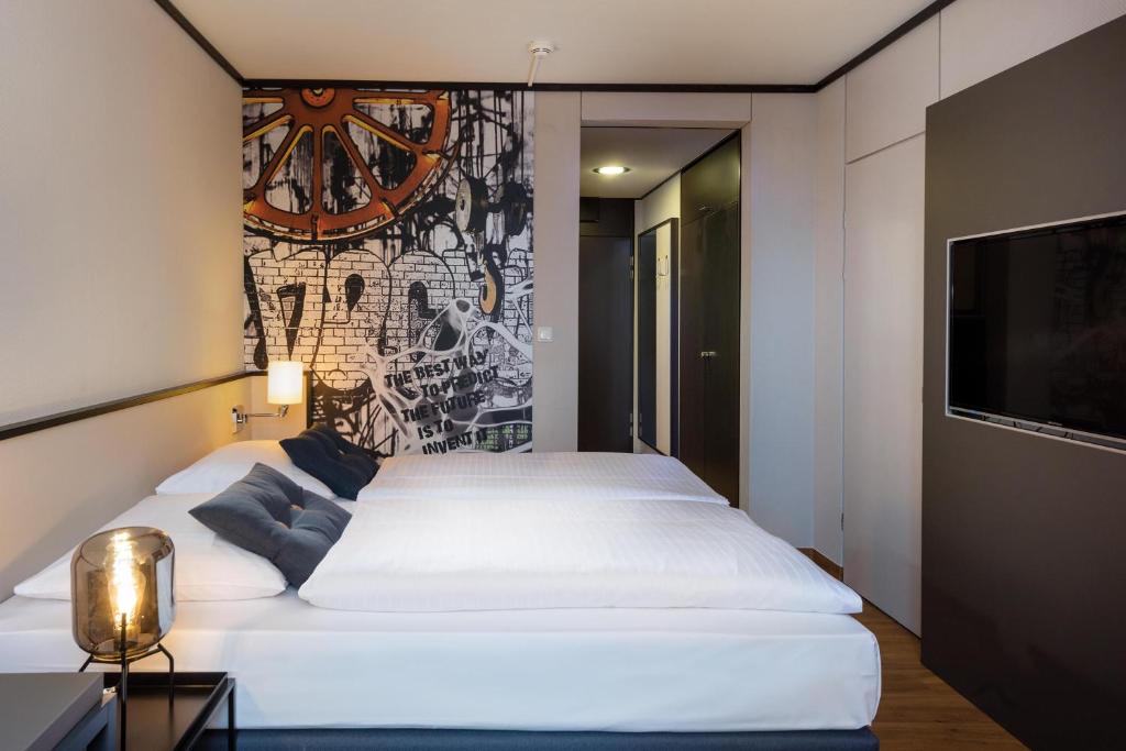 Postel nebo postele na pokoji v ubytování Seminaris Hotel Lüneburg