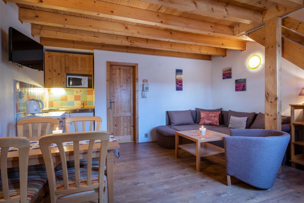 a living room with a couch and a table at Apartmán - Apartament Tatralandia 331 in Liptovský Mikuláš