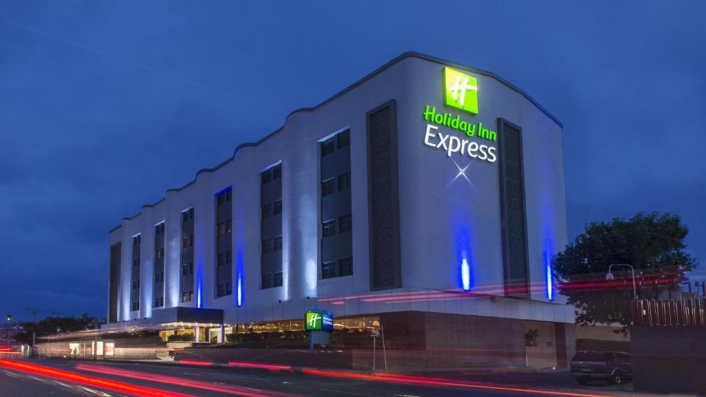 a building with a sign on the side of it at Holiday Inn Express Mexico- Toreo, an IHG Hotel in Mexico City