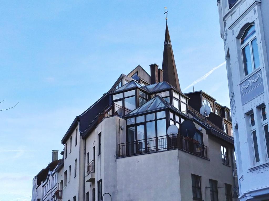 a building with a church steeple on top of it at Super Penthouse #9 oder Studio #6 mit Aufzug, Terrasse & Wintergarten im Zentrum in Eschweiler