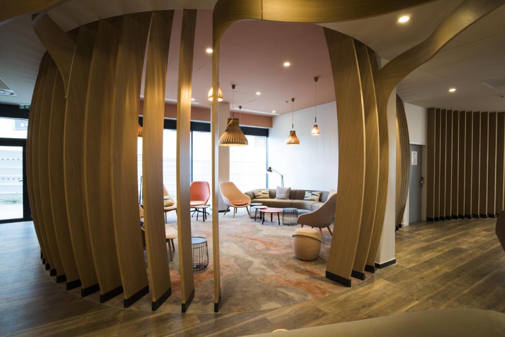 a living room with a large wall of surfboards at Holiday Inn Express - Paris - CDG Airport by IHG in Roissy-en-France