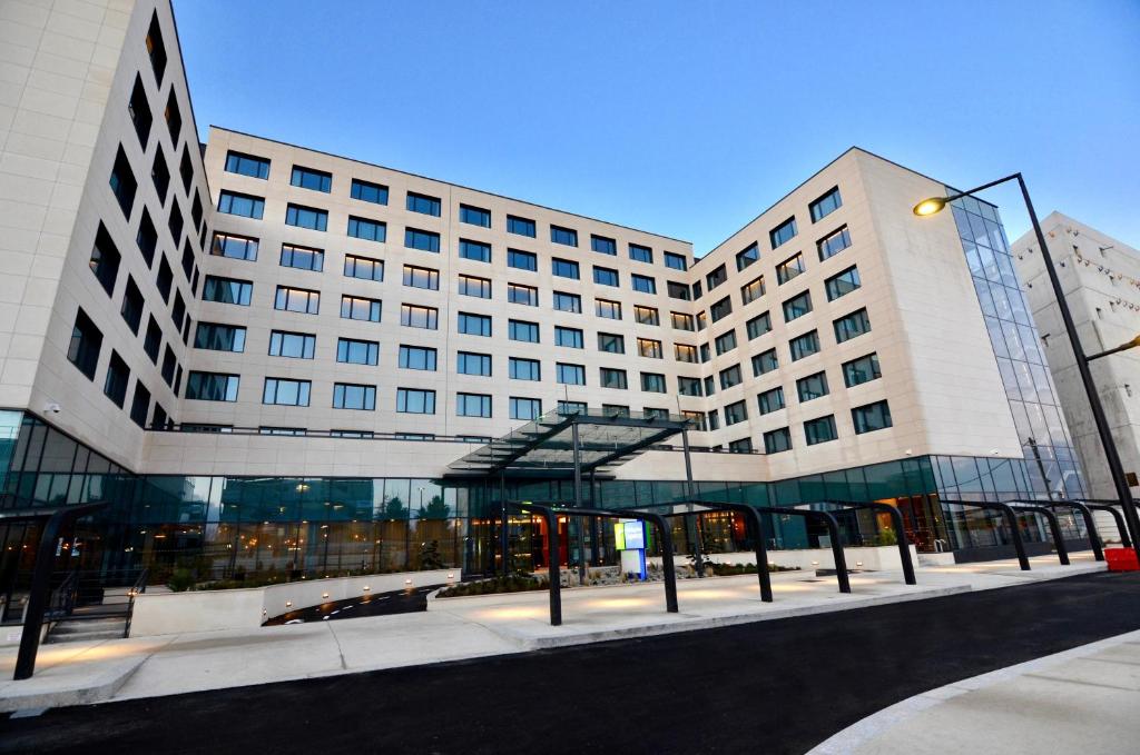 a large building with a street light in front of it at Holiday Inn Express - Paris - CDG Airport by IHG in Roissy-en-France