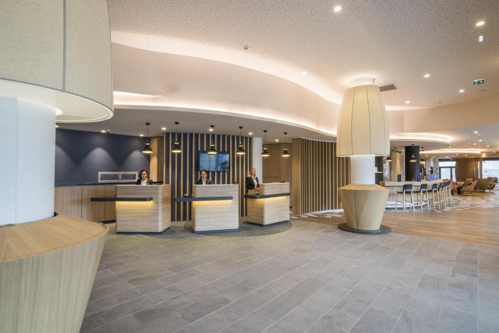 a lobby of a hotel with a reception desk at Holiday Inn Express - Paris - CDG Airport by IHG in Roissy-en-France