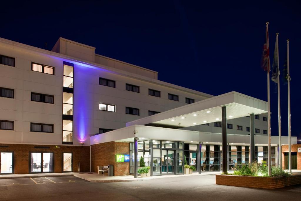 a building with a lit up facade at night at Holiday Inn Express Folkestone Channel Tunnel, an IHG Hotel in Folkestone