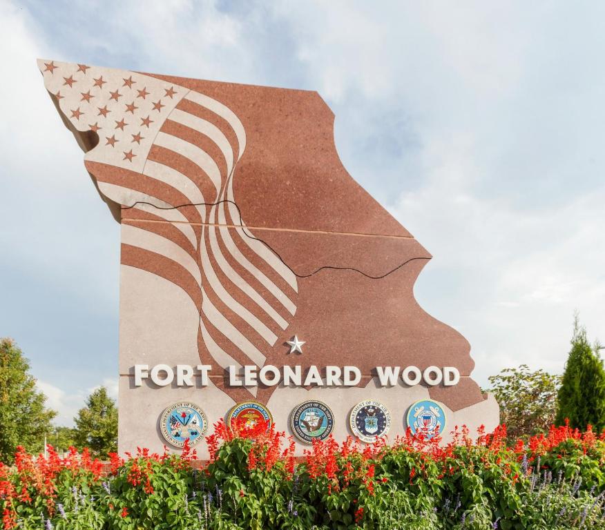 a sign with the american flag on it at Candlewood Suites St. Robert by IHG in Saint Robert