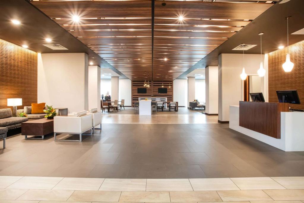 an office lobby with a waiting area with couches and tables at Wingate by Wyndham Denver Airport in Denver