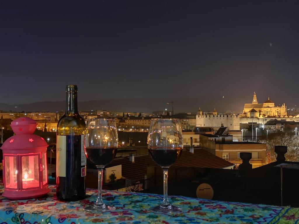 una mesa con dos copas de vino y una botella de vino en Spectacular views. All new with free parking, en Córdoba
