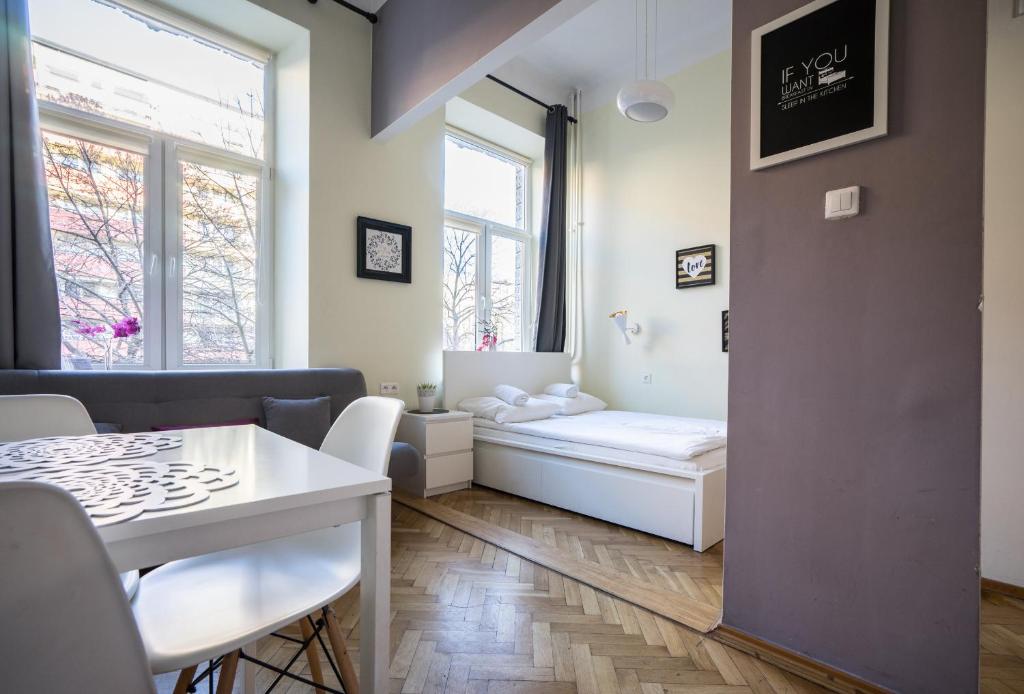 a small living room with a table and a window at Elegant Apartment Copernicus in Warsaw