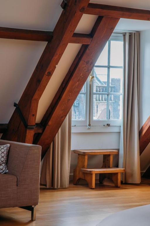 a living room with a couch and a window at Hotel ML in Haarlem