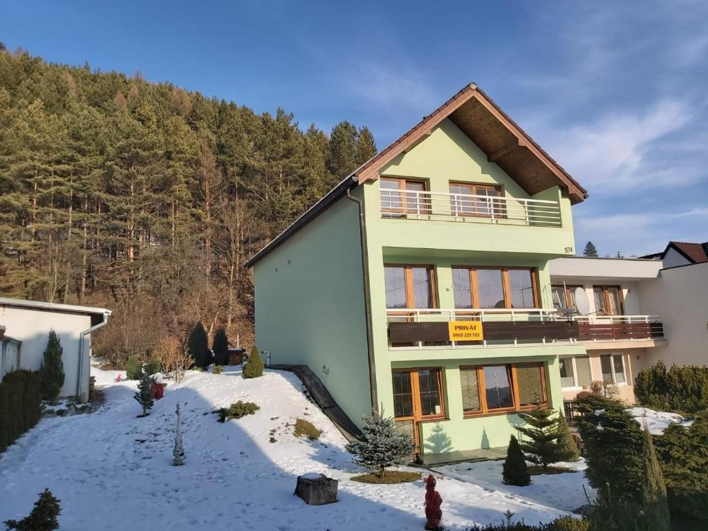 a house in the mountains with snow on the ground at Privát Ján in Lúčky